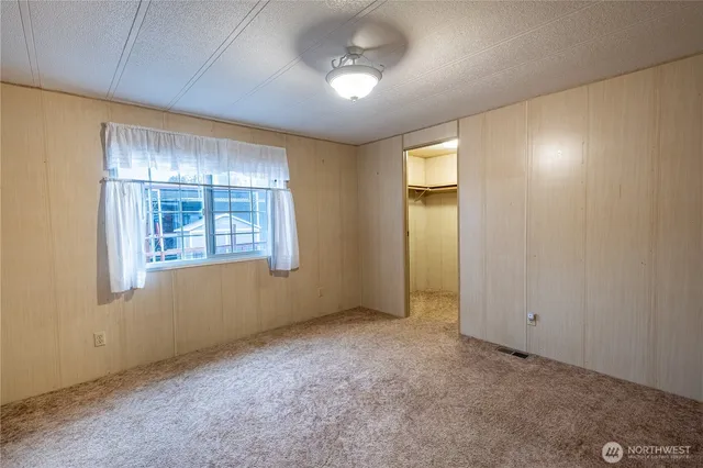 an empty room with windows and closet