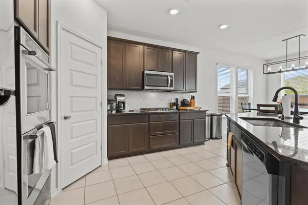 a kitchen with a sink stove and refrigerator