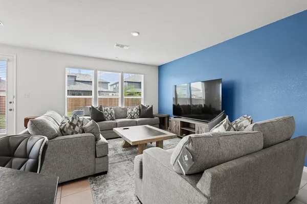 a living room with furniture and a flat screen tv
