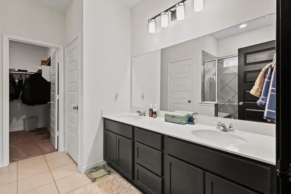 a bathroom with a double vanity sink a and mirror