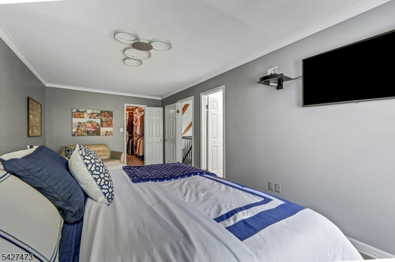 100 Easedale Road, Unit 100 Wayne, NJ 07470 - Photo 35 of 43 a bedroom with a large bed and a flat screen tv