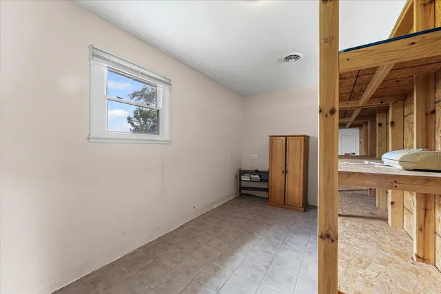 a view of balcony with wooden floor and fence