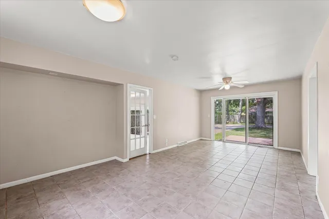 a front view of house with yard and trees in the background