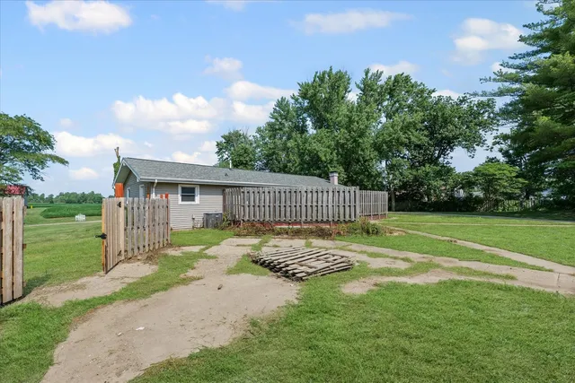 an aerial view of a house with swimming pool and outdoor space