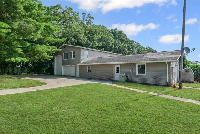 an aerial view of residential house with pool and trees