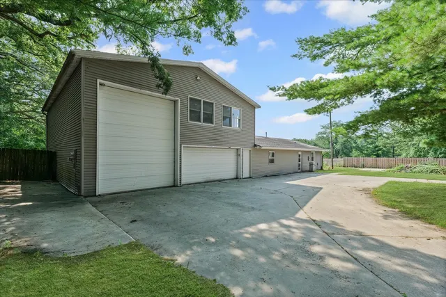 an aerial view of residential house with an outdoor space and seating