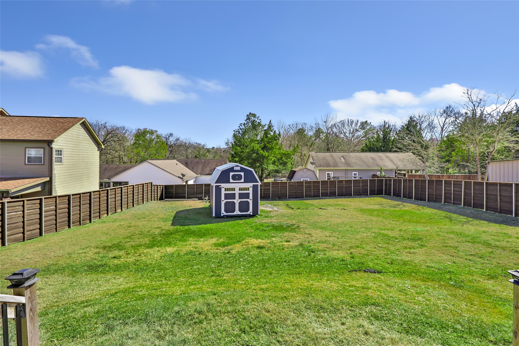 140 Swann Lane Coldspring, TX 77331 - Photo 7 of 30 Spacious, fully fenced back yard with storage shed.