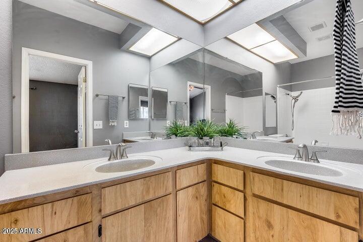 3339 West Mohawk Lane Phoenix, AZ 85027 - Photo 16 of 27 a bathroom with a sink and a mirror