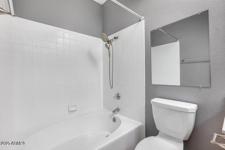 3339 West Mohawk Lane Phoenix, AZ 85027 - Photo 17 of 27 a white toilet sitting next to a bath tub