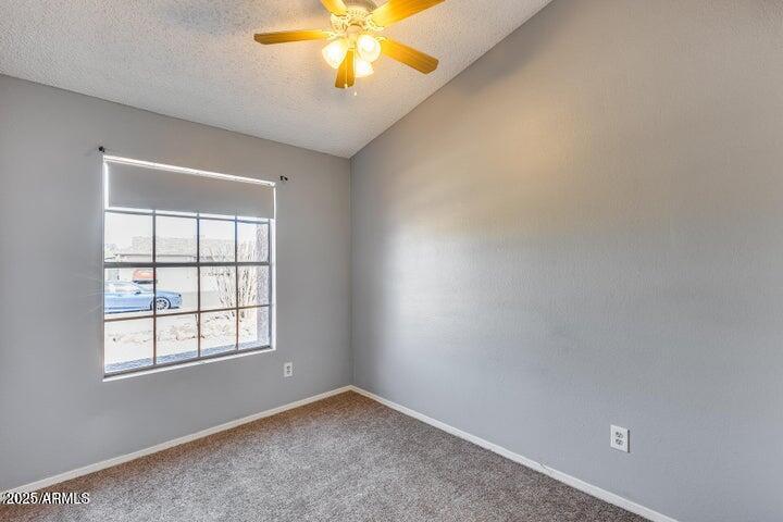 3339 West Mohawk Lane Phoenix, AZ 85027 - Photo 19 of 27 an empty room with windows and chandelier fan