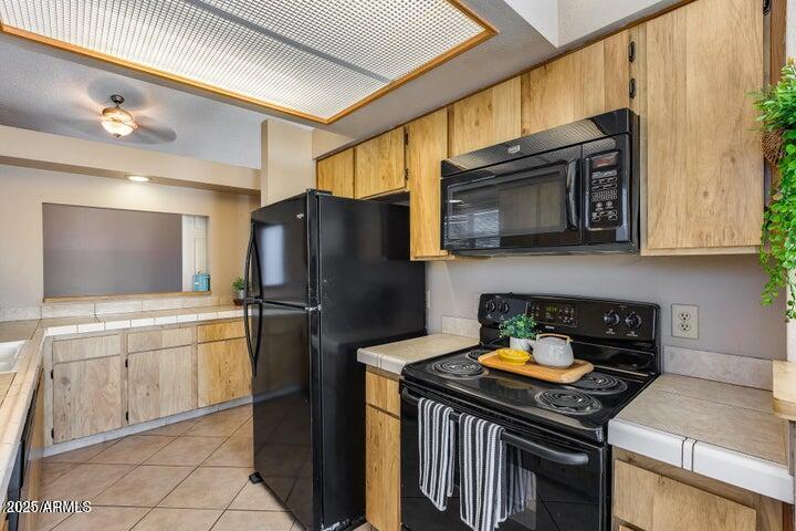 3339 West Mohawk Lane Phoenix, AZ 85027 - Photo 2 of 27 a kitchen with stainless steel appliances granite countertop a stove a refrigerator and a microwave