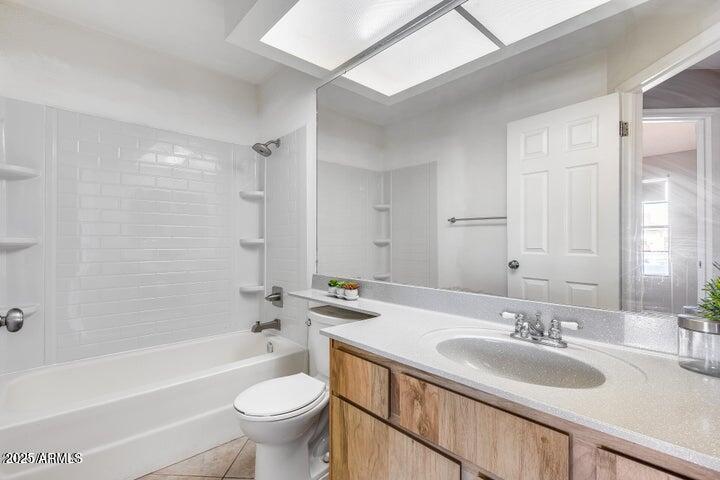 3339 West Mohawk Lane Phoenix, AZ 85027 - Photo 22 of 27 a bathroom with a granite countertop sink a toilet a mirror and bathtub