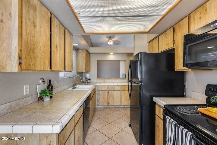 3339 West Mohawk Lane Phoenix, AZ 85027 - Photo 3 of 27 a kitchen with stainless steel appliances granite countertop a sink a stove a refrigerator a washer dryer and white cabinets