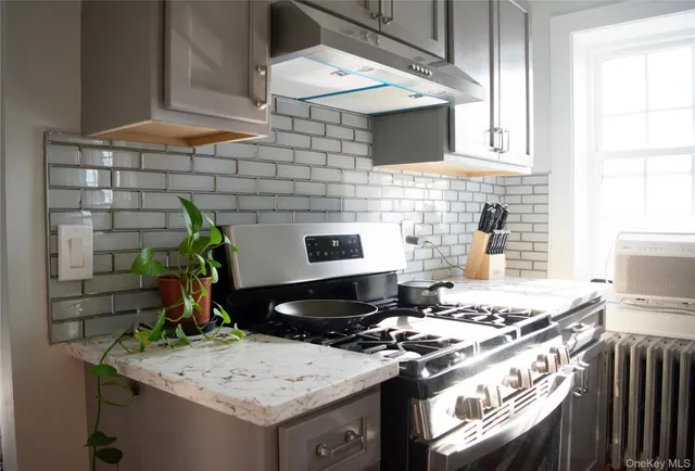 a stove top oven sitting inside of a kitchen