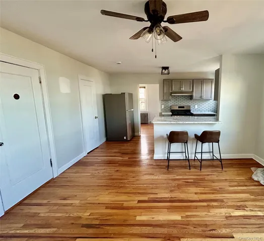 a view of kitchen with microwave and refrigerator