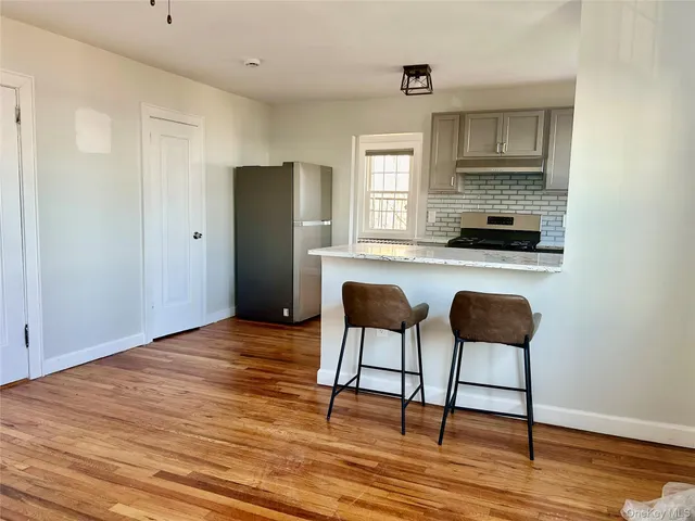 a kitchen with stainless steel appliances granite countertop a refrigerator and a stove top oven