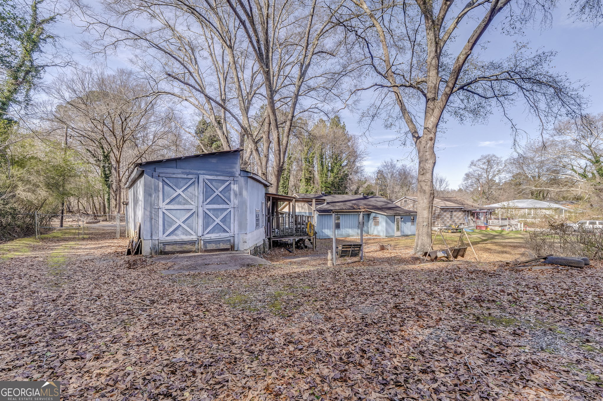 13 Kennemore Road Rome, GA 30165 - Photo 11 of 13 a backyard of a house with large trees and a barn