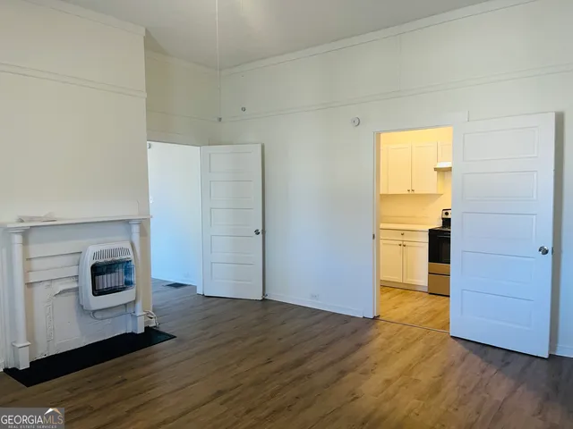 a view of a kitchen with wooden floor and electronic appliances