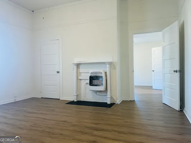a view of a room with wooden floor and fireplace