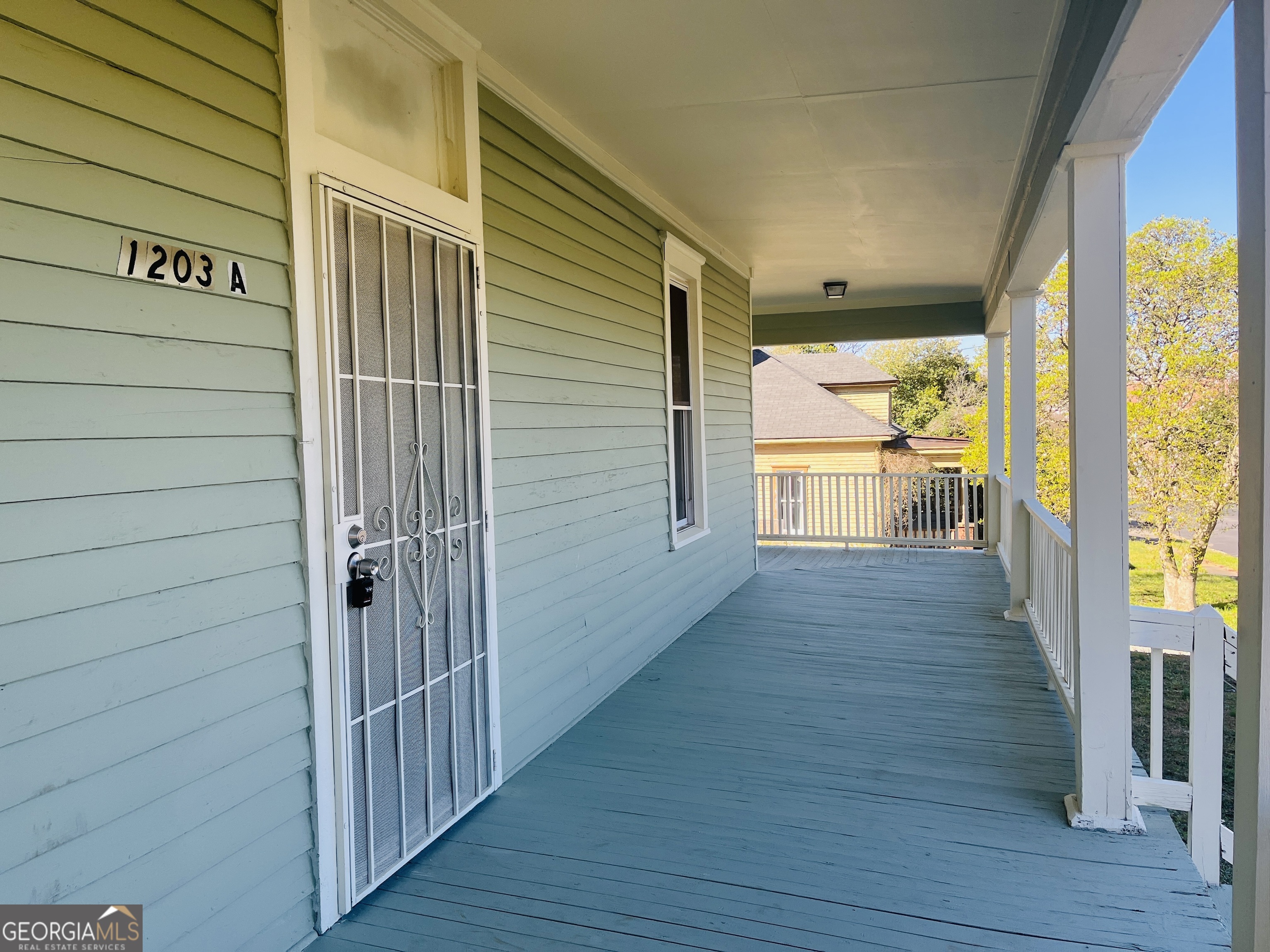 1203 1st Avenue, Unit A LaGrange, GA 30240 - Photo 3 of 17 a view of a porch with wooden floor and furniture