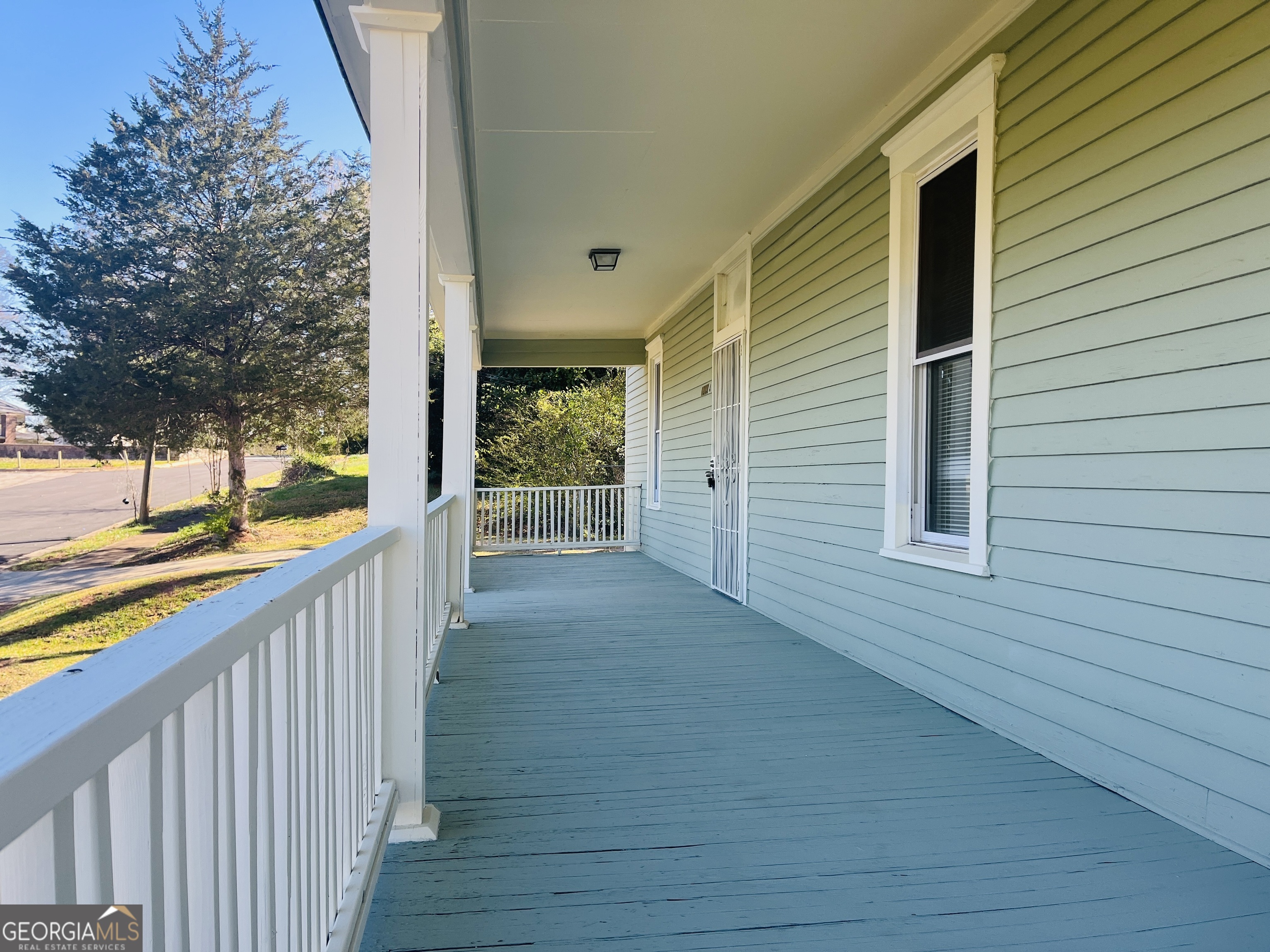 1203 1st Avenue, Unit A LaGrange, GA 30240 - Photo 4 of 17 a view of a balcony with wooden floor and fence