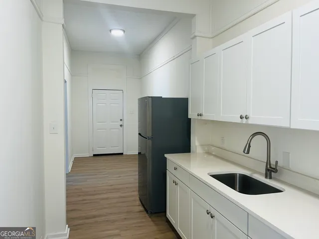 a kitchen with a refrigerator and cabinets