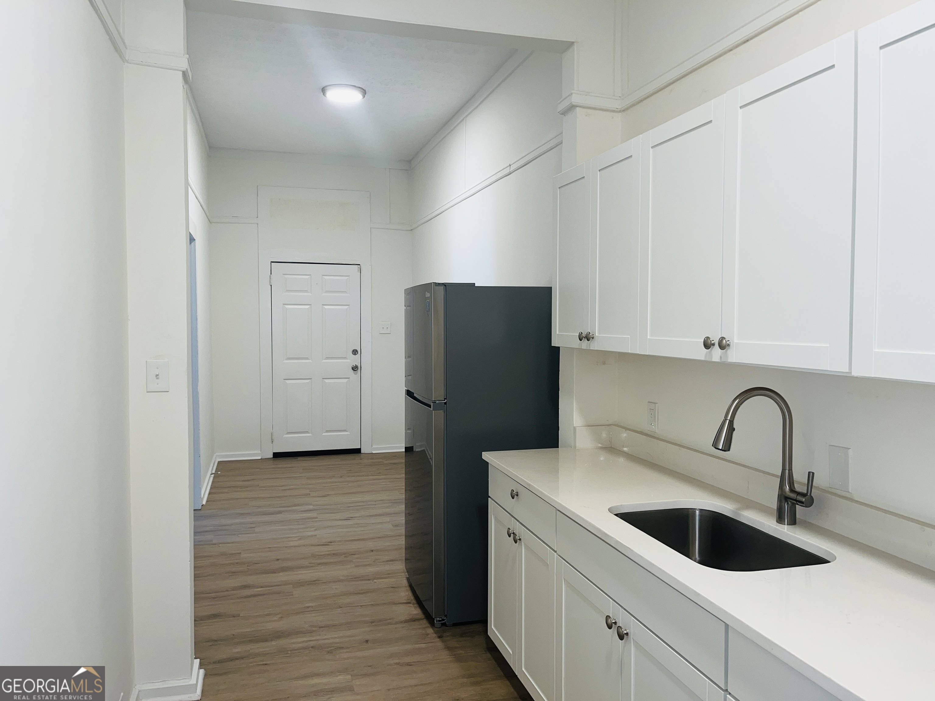 1203 1st Avenue, Unit A LaGrange, GA 30240 - Photo 6 of 17 a kitchen with a refrigerator and cabinets