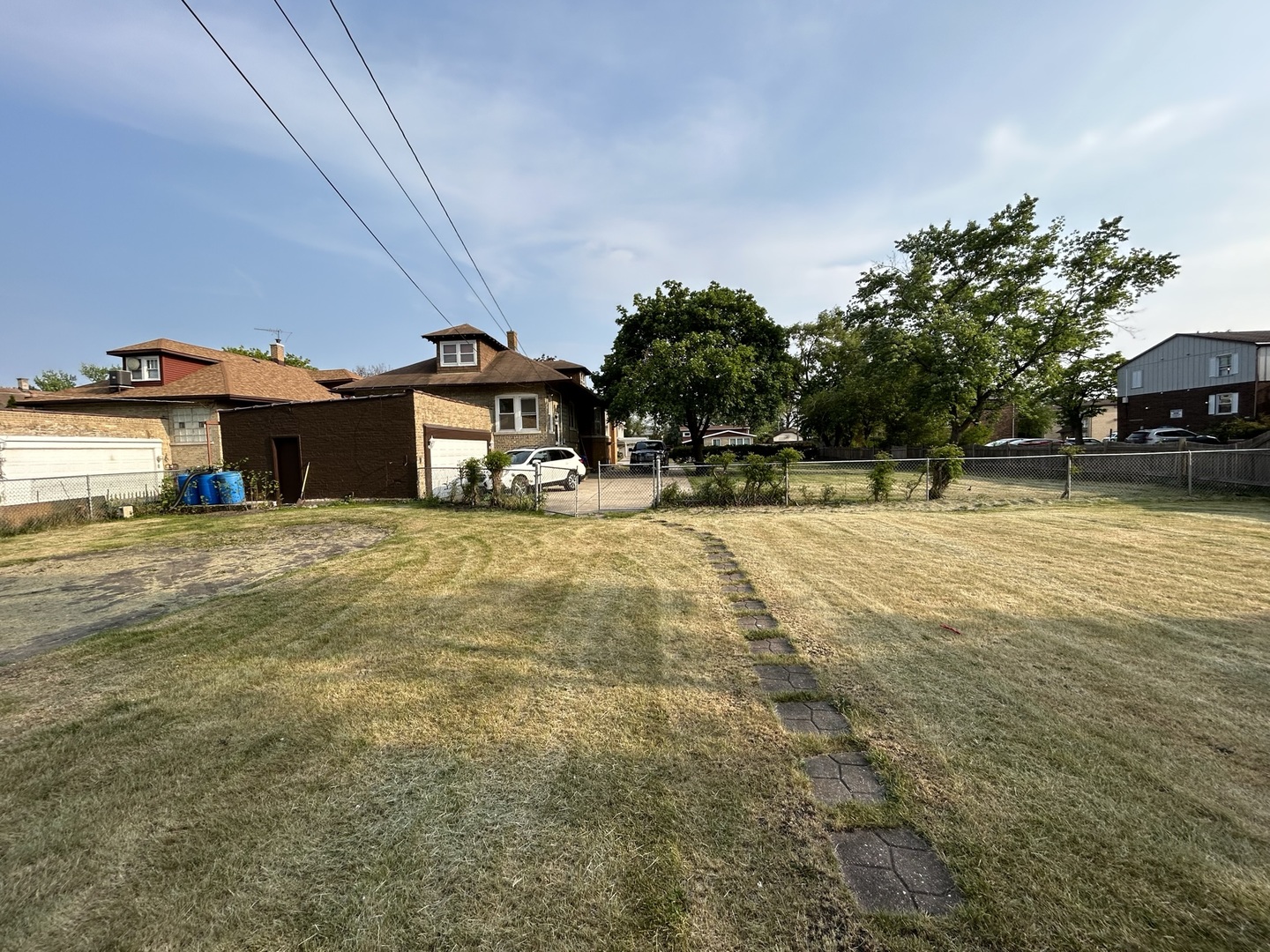 7904 45th Place Lyons, IL 60534 - Photo 23 of 26 a view of a swimming pool with lawn chairs and plants