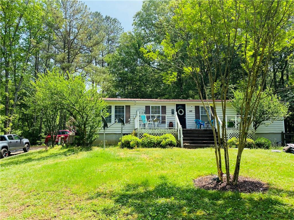 148 Pine Tree Path Dallas, GA 30132 - Photo 1 of 1 a front view of a house with garden