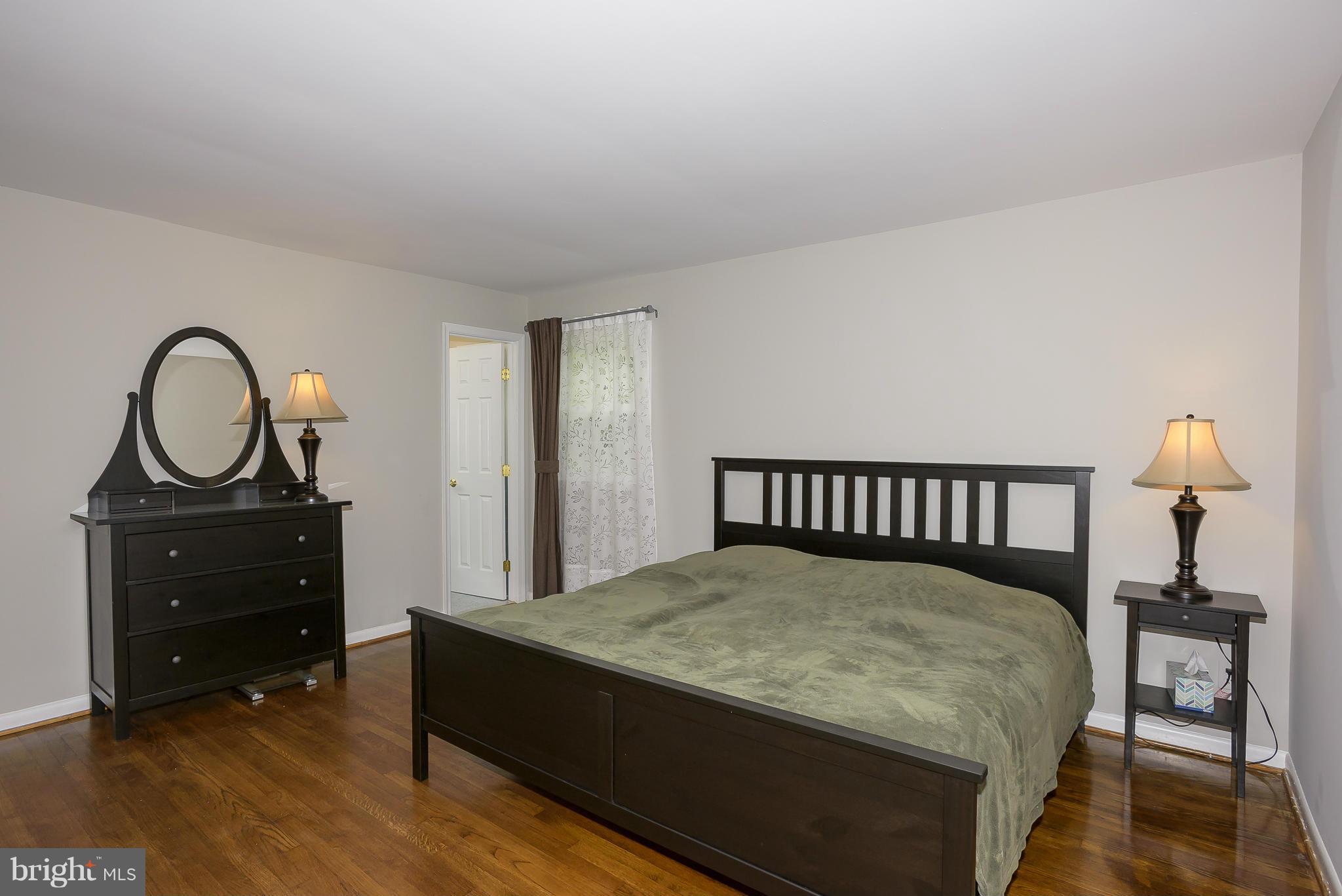 13007 Broadmore Road Silver Spring, MD 20904 - Photo 14 of 30 a bedroom with a bed and a dresser