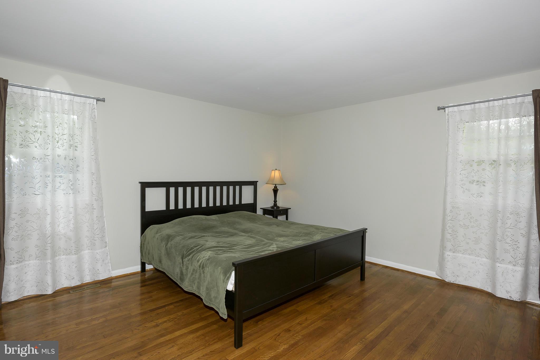 13007 Broadmore Road Silver Spring, MD 20904 - Photo 15 of 30 a bed sitting in a bedroom next to a window