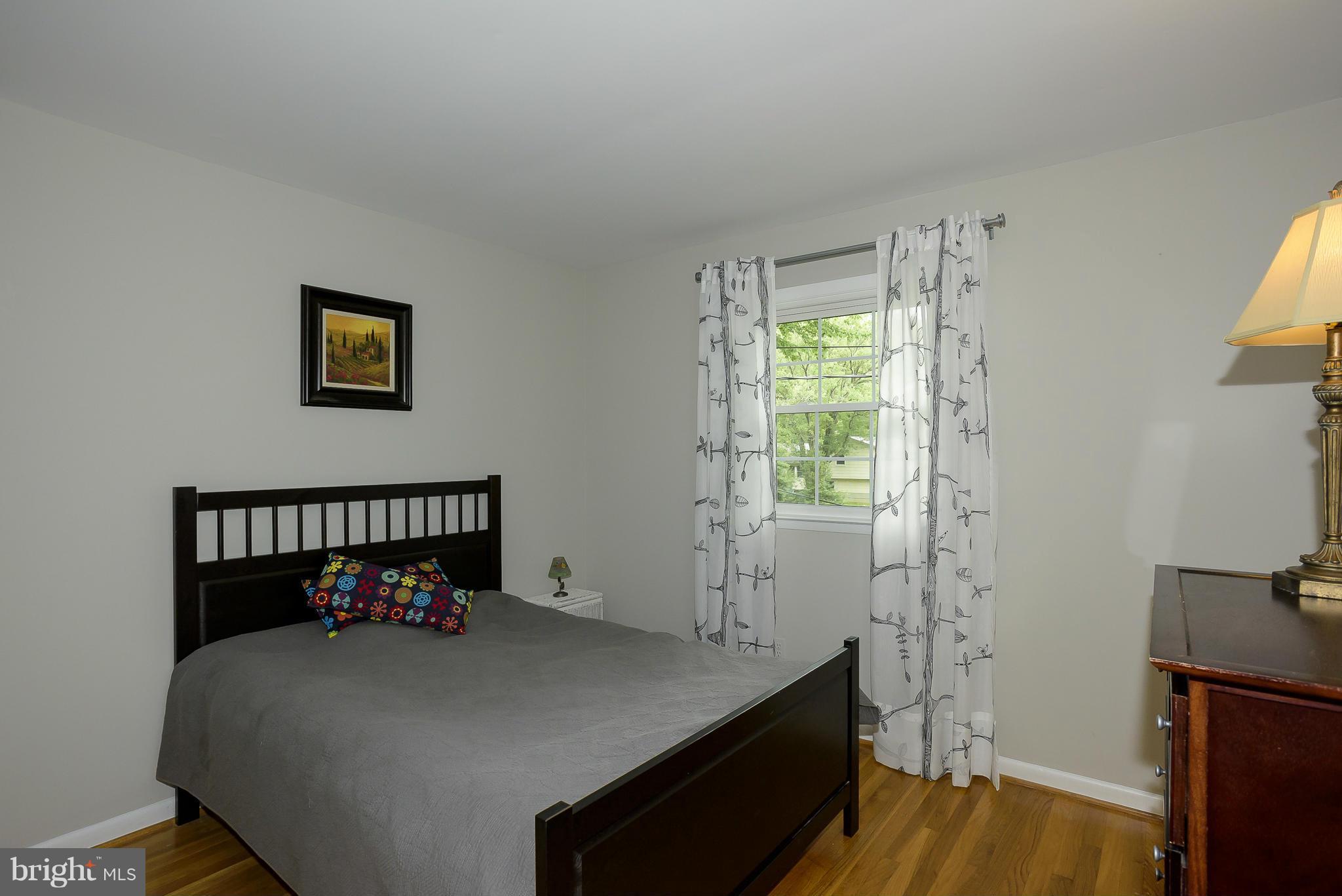 13007 Broadmore Road Silver Spring, MD 20904 - Photo 18 of 30 a bed sitting in a bedroom next to a window