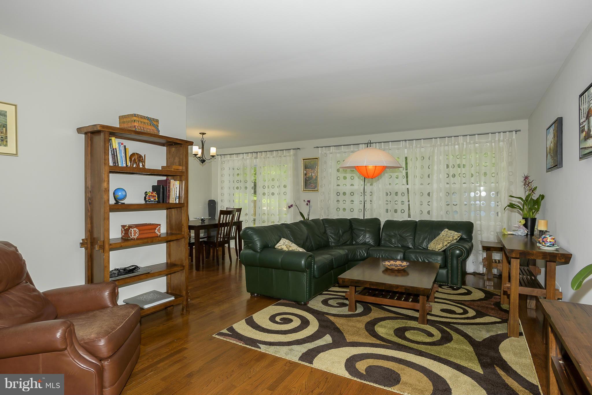 13007 Broadmore Road Silver Spring, MD 20904 - Photo 3 of 30 a living room with furniture and wooden floor