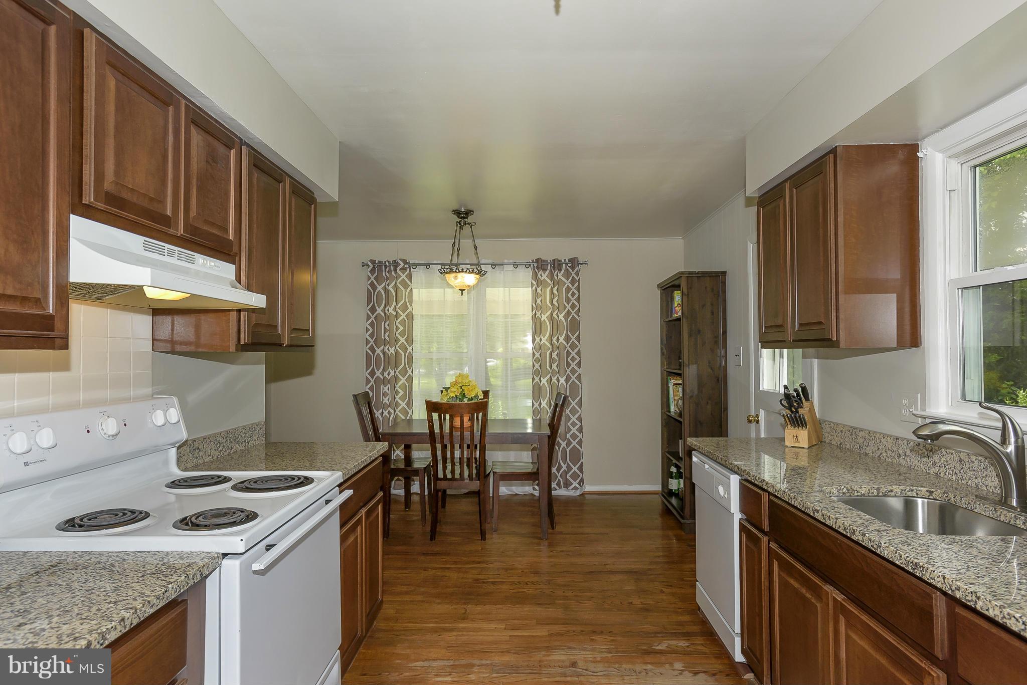 13007 Broadmore Road Silver Spring, MD 20904 - Photo 4 of 30 a kitchen with granite countertop a sink stove and cabinets