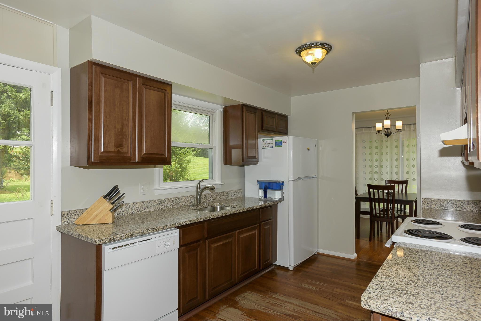 13007 Broadmore Road Silver Spring, MD 20904 - Photo 5 of 30 a kitchen with a sink and a refrigerator