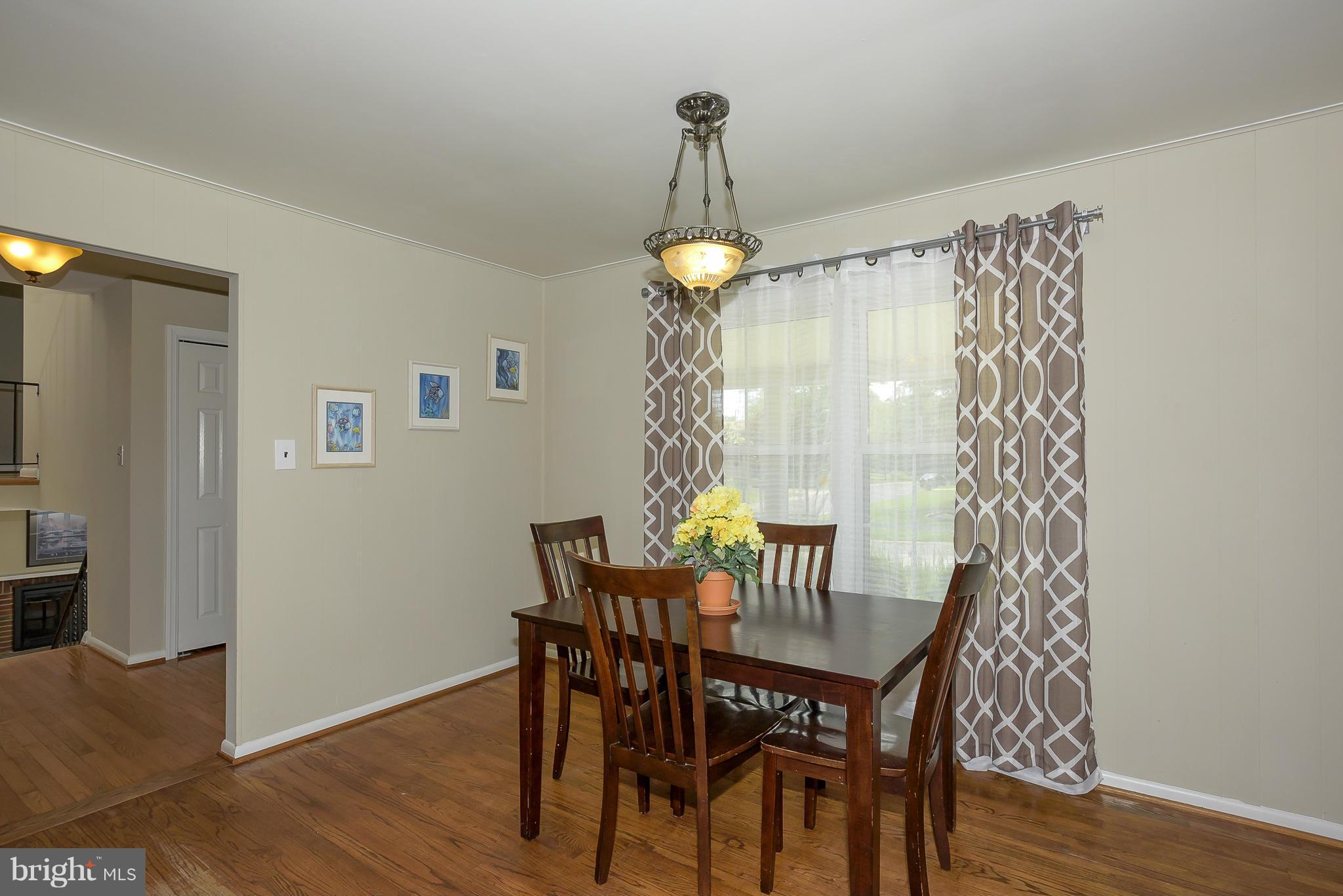 13007 Broadmore Road Silver Spring, MD 20904 - Photo 8 of 30 a dining room with furniture wooden floor a chandelier