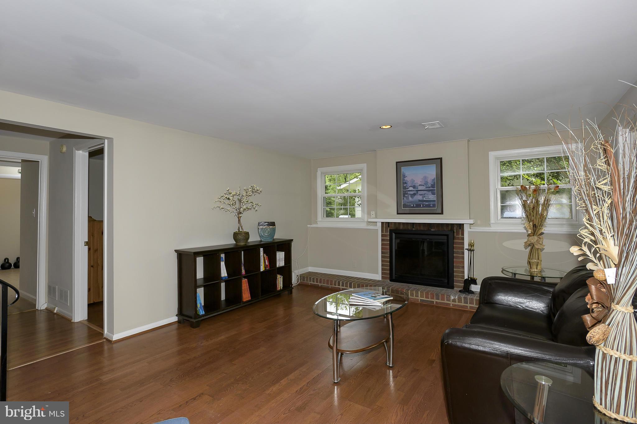 13007 Broadmore Road Silver Spring, MD 20904 - Photo 9 of 30 a living room with furniture a fireplace and a window