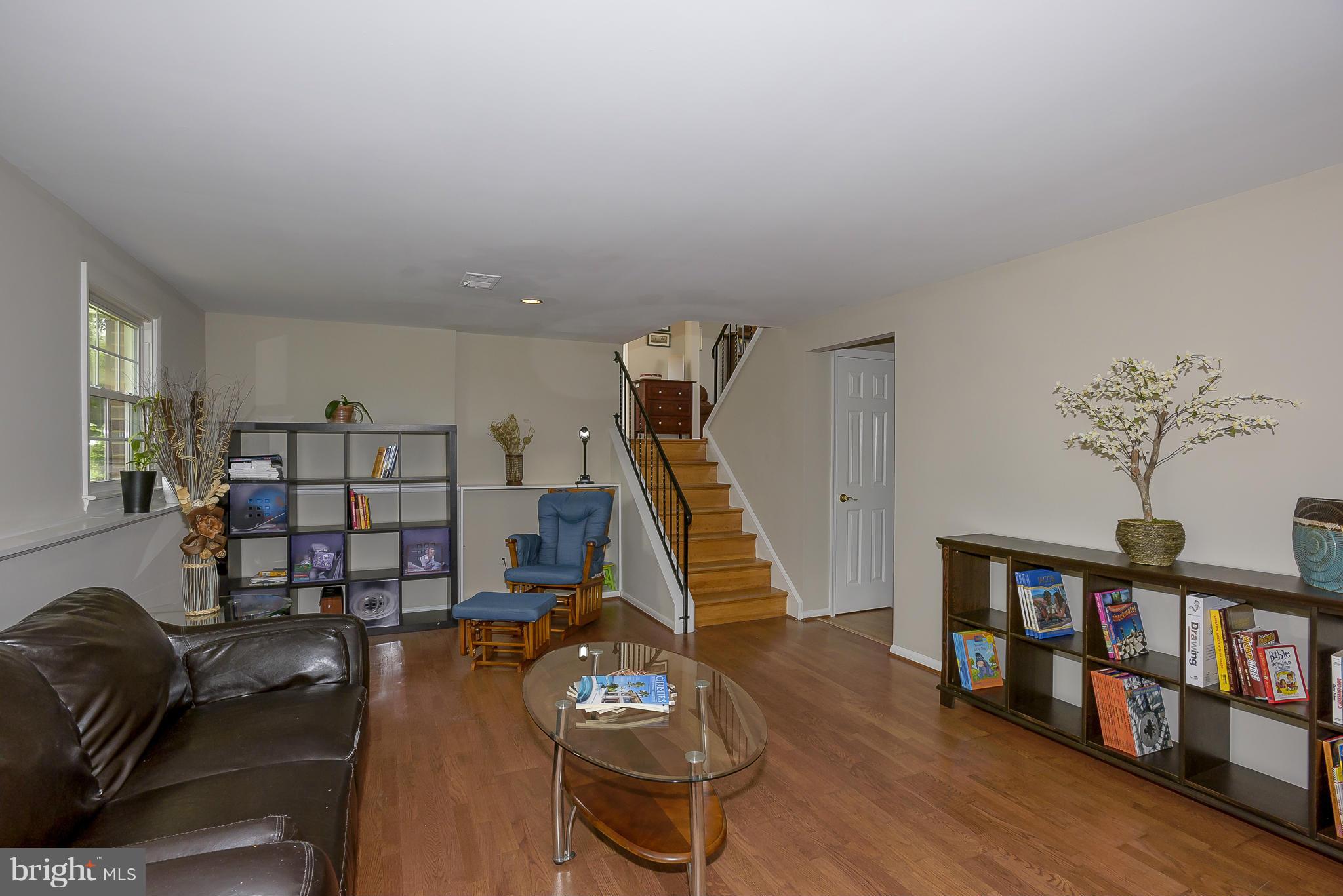 13007 Broadmore Road Silver Spring, MD 20904 - Photo 10 of 30 a living room with furniture and a wooden floor