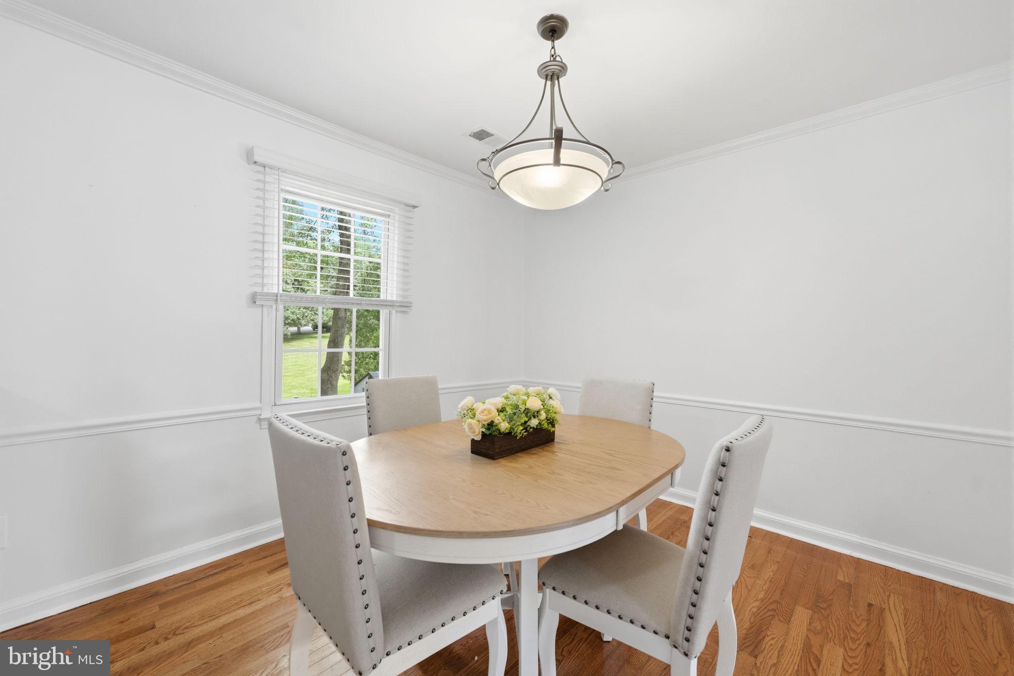 8260 Getty Court Springfield, VA 22153 - Photo 9 of 31 a view of a dining room with furniture and wooden floor