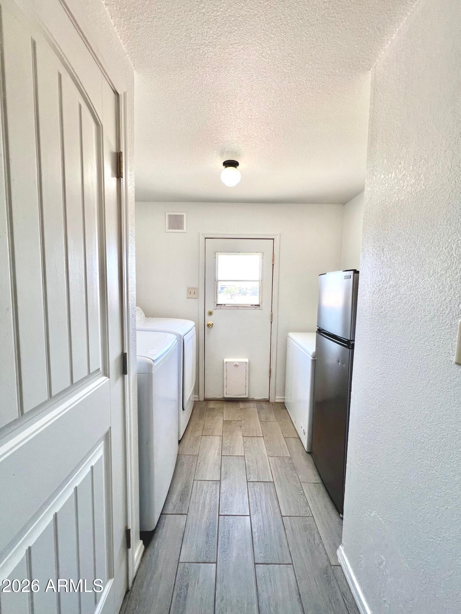 12035 East Tennyson Road Florence, AZ 85132 - Photo 16 of 42 a view of a kitchen from a hallway with wooden floor