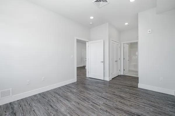 a view of hallway with a wooden floor