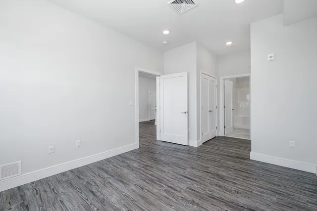 a view of hallway with a wooden floor