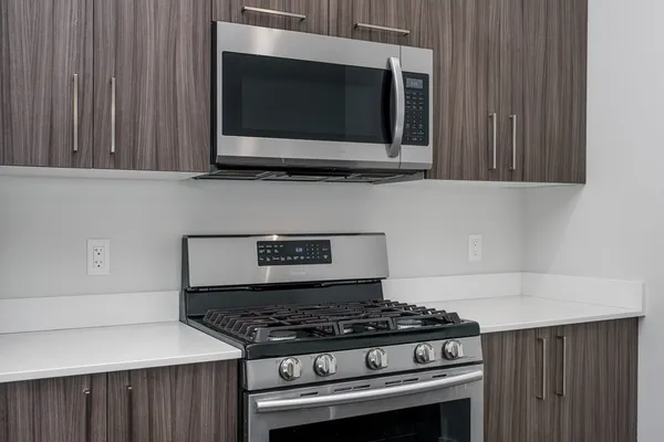 a stove top oven sitting inside of a kitchen
