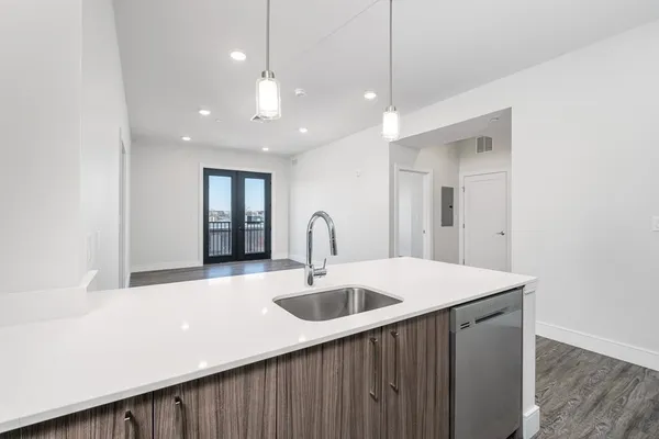 a kitchen with a sink and a refrigerator