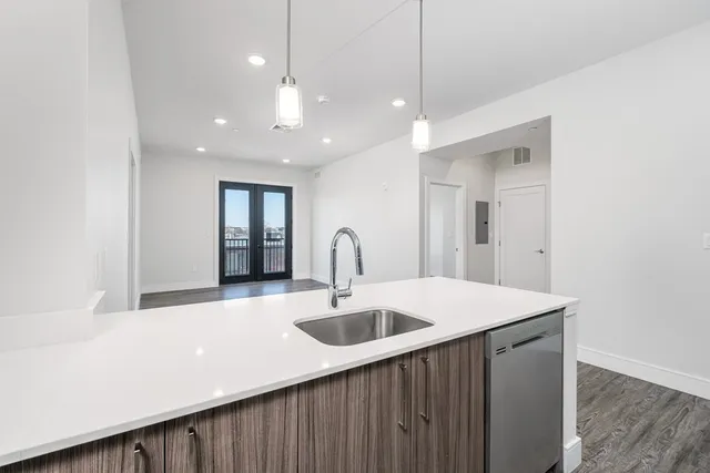 a kitchen with a sink and a refrigerator