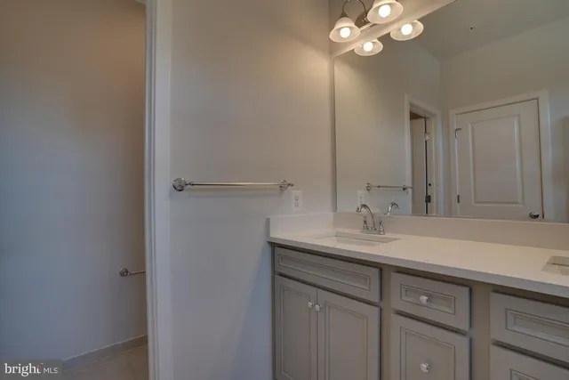 a bathroom with a sink vanity and mirror