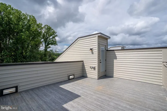 a view of a deck with wooden floor and fence