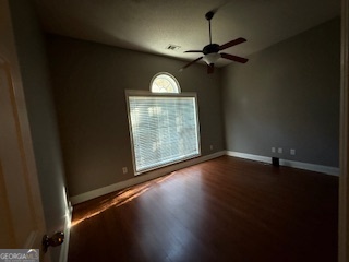 322 Pheasant Ridge Drive Warner Robins, GA 31088 - Photo 16 of 19 an empty room with wooden floor fan and windows