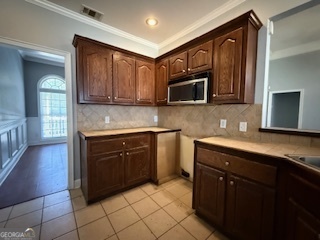 322 Pheasant Ridge Drive Warner Robins, GA 31088 - Photo 6 of 19 a kitchen with stainless steel appliances granite countertop a stove microwave and cabinets
