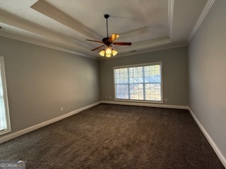 322 Pheasant Ridge Drive Warner Robins, GA 31088 - Photo 10 of 19 an empty room with windows and chandelier fan